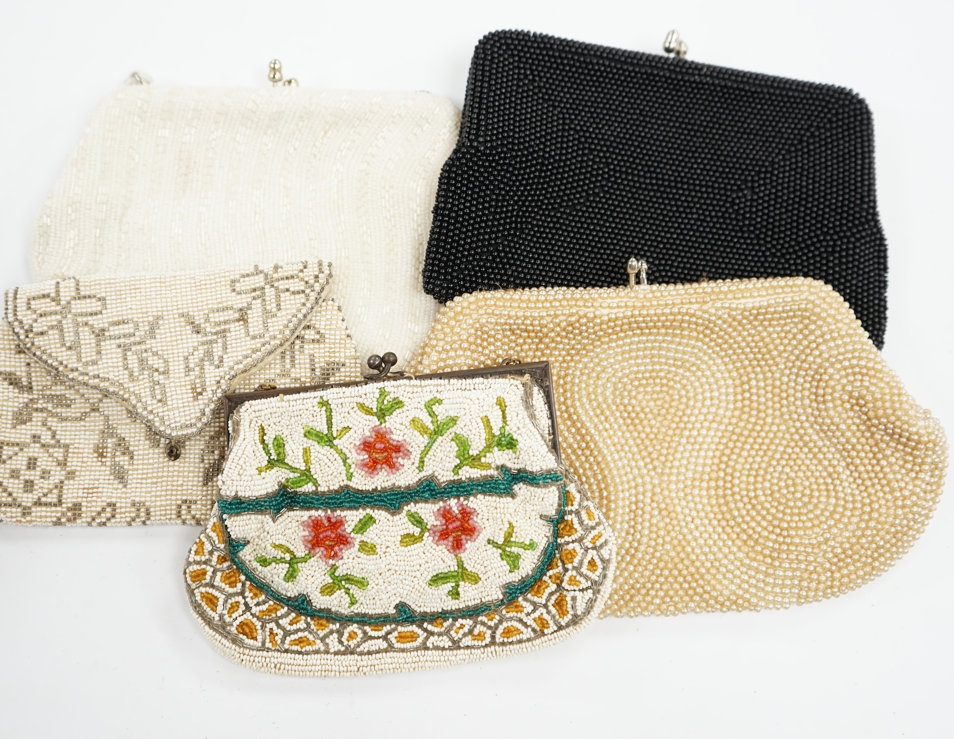 A collection of 1940’s-50’s beaded evening bags and clutch bags, largest 19cm high. (9). Condition - exterior good, a few interiors of bags marked from use